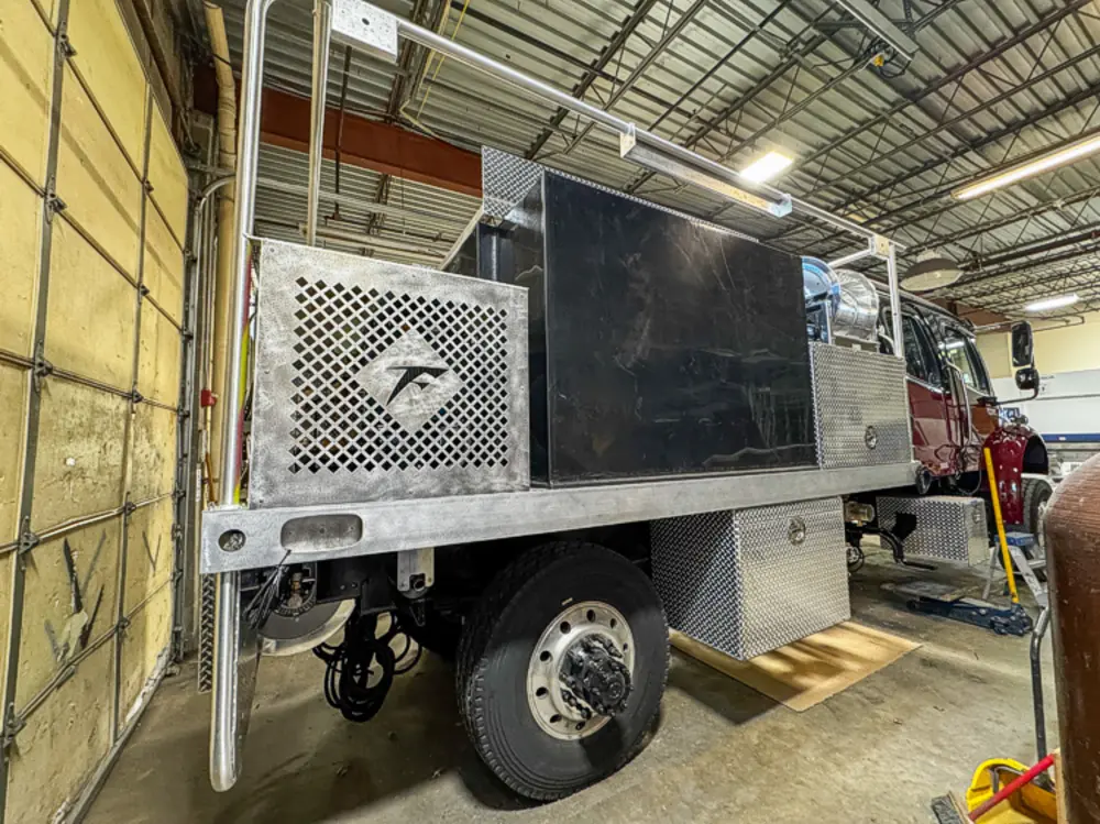 Diamond-plate body and step detail in production, photo 78 of 303.